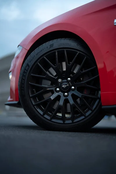 Wroclaw, Poland - August 15, 2022: Close-up of Ford Mustang 19 inch wheels with pony logo and Michelin Pilot Sport 4s performance tires