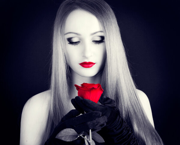 Portrait of beautiful girl with red rose