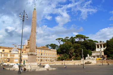 Rome, Italy - September 24, 2020: the Egyptian obelisk from Heliopolis that stands in the middle of Piazza del Popolo and Pincio in Rome, Italy. Some people around.