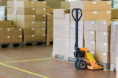 shipping warehouse with cartons and a forklift for handling - industrial interior