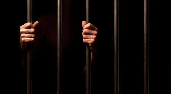 Handen Van Een Gevangene Achter Gevangenis Bars Zwarte Achtergrond Stockfoto