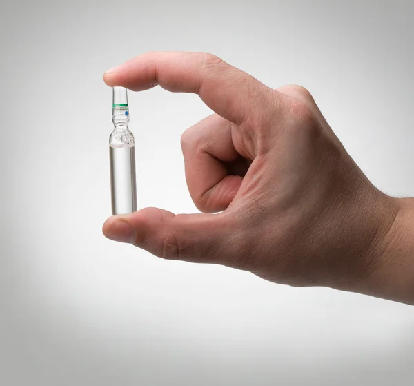 Ampoule in a hand — Stock Photo, Image