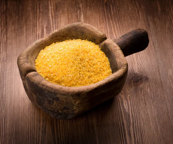Corn grits on wooden — Stock Photo, Image