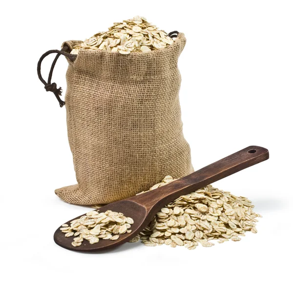 Bag of oats and a wooden spoon — Stock Photo, Image