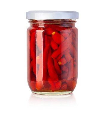 canned red peppers in a glass jar isolated on a white background with clipping path