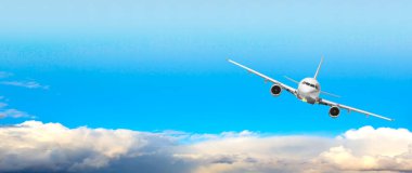 passenger plane flying against  sky is large, bright, beautiful and has white clouds.