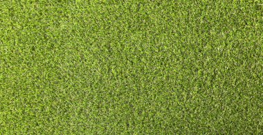 Natural background green artificial grass, top view