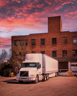 Manufacturing plant Truck dock for shipment load  at dawn