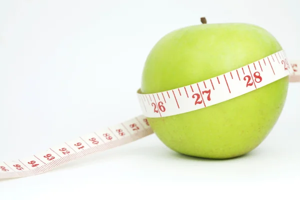 Fresh apple with measuring tape — Stock Photo, Image