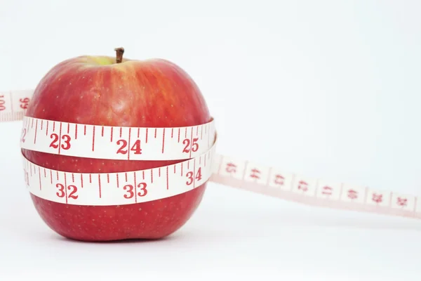 Fresh apple with measuring tape — Stock Photo, Image