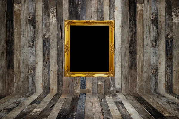 Golden photo frame in old room — Stock Photo, Image