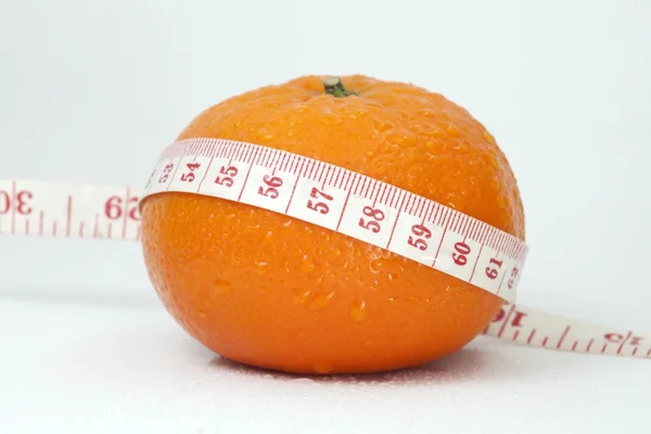 Orange and measuring tape — Stock Photo, Image
