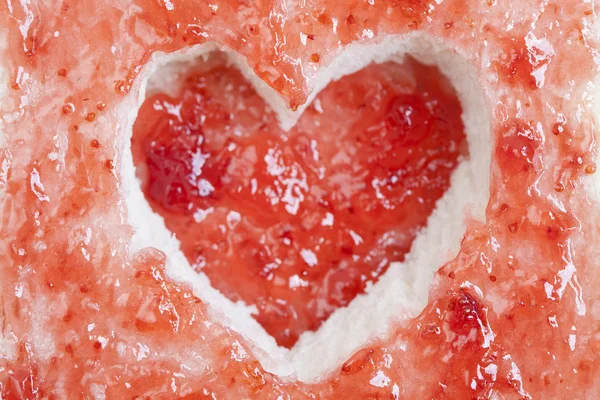 Slice of bread with fruit jam heart shape — Stock Photo, Image