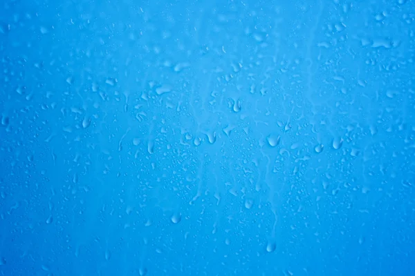 Raindrops on blue background — Stock Photo, Image