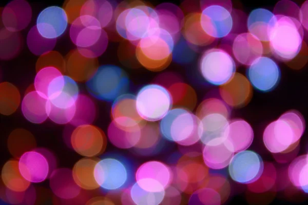 Color Bokeh against a dark background — Stock Photo, Image