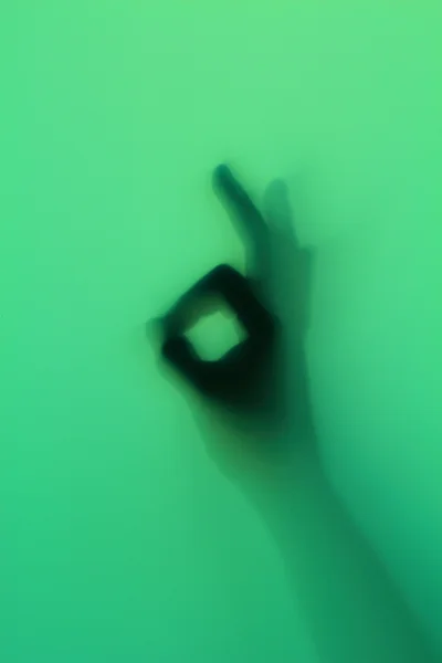 Hand silhouet op groen glas — Stockfoto