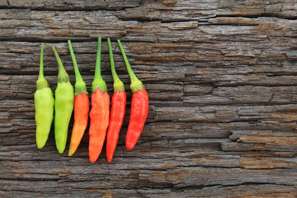 Hot chili peppers on old wooden — Stock Photo, Image