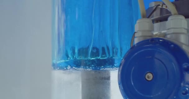 Modern pump equipment.beautifully illuminated liquid is pumped in a transparent glass tube.close-up.water treatment.technology background.close-up — Stock Video
