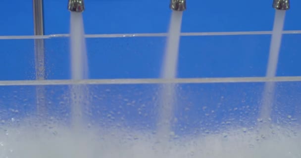 Jets of clean water are poured from the metal taps of the mixers.Close-up — Stock Video