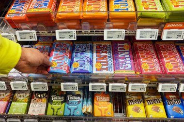 NETHERLANDS - DECEMBER 2021: Tony's Chocolonely bars in an Albert Heijn supermarket. Tony's Chocolonely is a Dutch confectionery company striving to produce for slave-free chocolate.