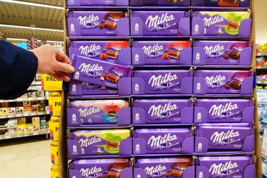 GERMANY - APRIL 2022: Display with a range of Milka chocolate bars in a Kaufland supermarket. Milka is a traditional Swiss brand of chocolate confection, manufactured by US-american Mondelz International