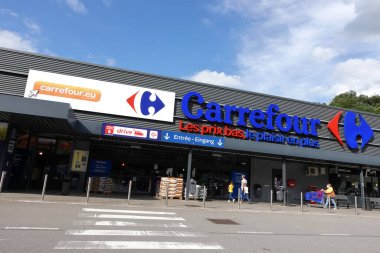 MALMEDY, BELGIUM - JULY 2021: Entrance of a Carrefour hypermarket. Carrefour is a French multinational retailer and one of the largest hypermarket chains in the world.