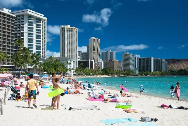 Touristen sonnen sich und surfen am Strand von Waikiki auf Hawaii. — Stockfoto