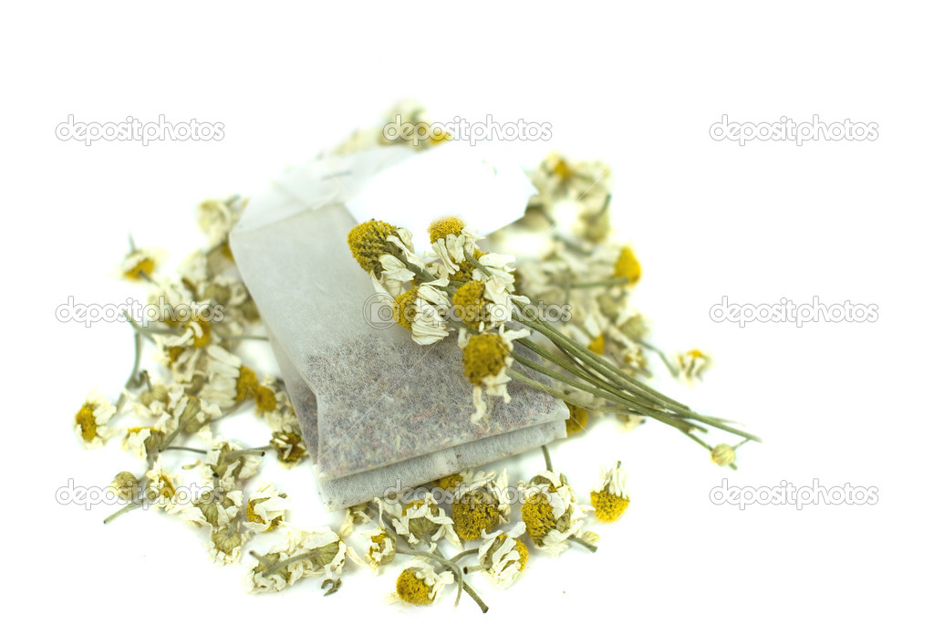 Bag of chamomile tea on white background