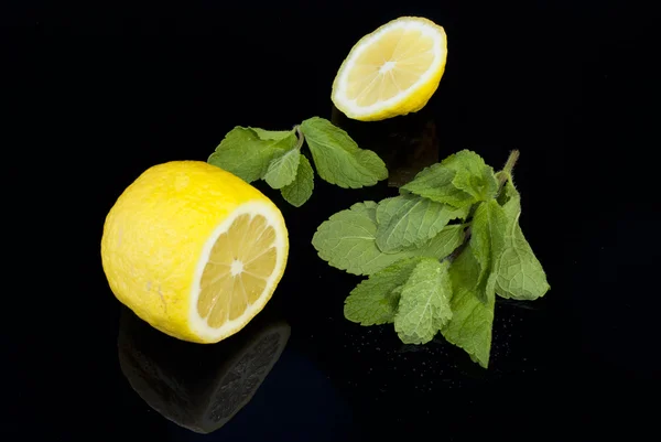 Limón y menta sobre fondo negro — Foto de Stock