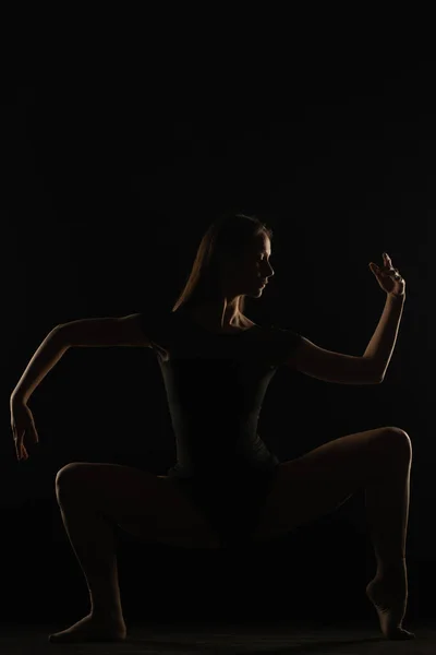 Silueta Bailarina Femenina Está Haciendo Una Pose Asimétrica Estudio —  Fotos de Stock