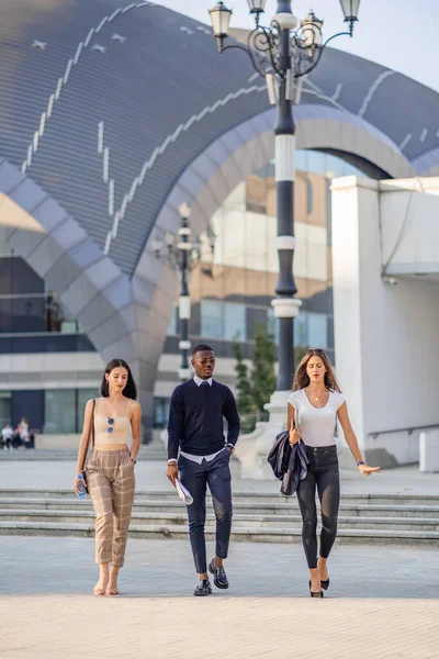 Three Multiracial Business People Walking Fast While Discussing — Stock Photo, Image