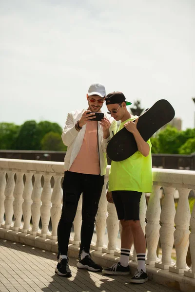 Two Male Friends Watching Something Phone Smiling — Stockfoto