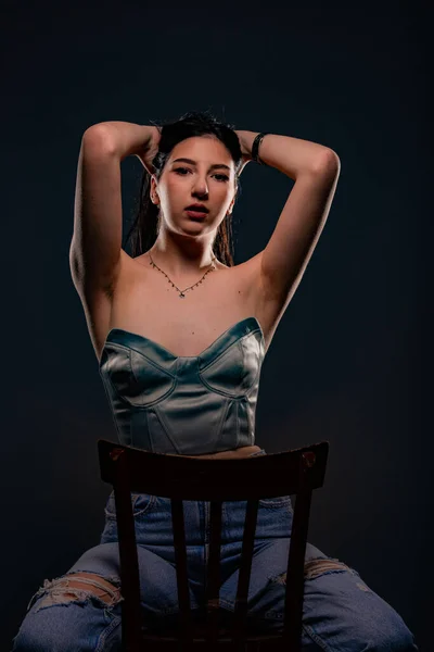 Beautiful Attractive Young Girl Posing Chair Studio While Holding Her — Stockfoto