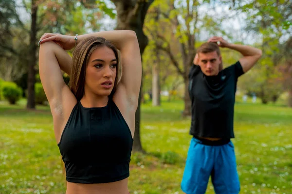 Photo Young Focused Man Woman Wearing Sportswear Doing Stretching Exercises — Fotografia de Stock