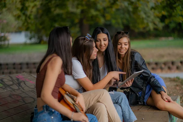 Four Amazing Adorablke Girls Looking Tablet Showing Something — Stockfoto
