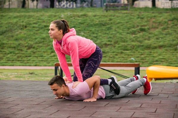 Attractive Handsome Guy Trying Push While His Girl Top Him — стоковое фото