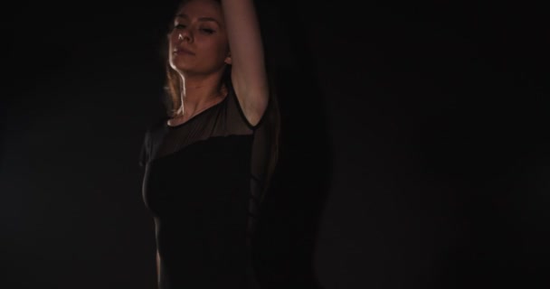 美しいバレリーナありますダンス完全にでスタジオ上の暗い背景 — ストック動画