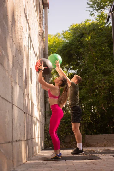 Hermosa Pareja Está Lanzando Las Bolas Ejercicio Mientras Entrenan Juntos —  Fotos de Stock