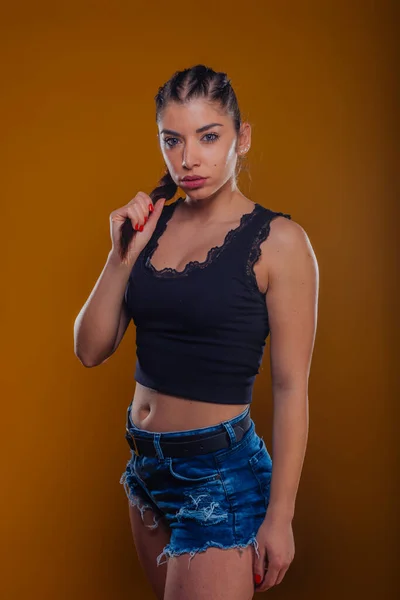 Young Girl Denim Shorts Black Crop Top Posing Orange Light — Stock Photo, Image
