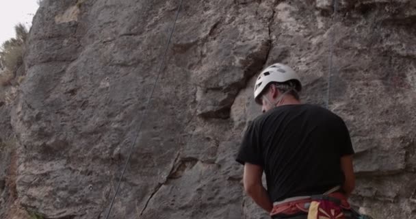 Handsome Fit Senior Male Start Climbing Big Rock — Stock Video