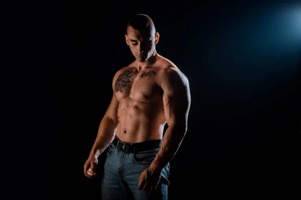 Fit man black background. Fit athlete show muscles. Strong sportsman with fit body