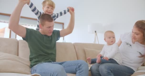 Père Joue Avec Son Fils Pendant Que Mère Tient Fille — Video