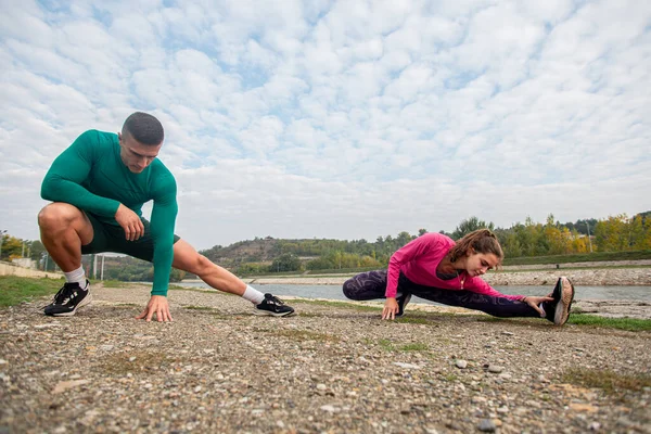 Beautiful Couple Stretching Legs Together While Warming Training — Stock fotografie