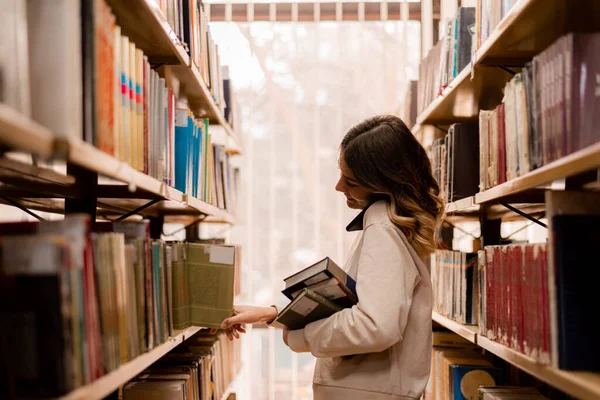 Girl Taking Book Bookshelves Library While Talking Phone — Zdjęcie stockowe