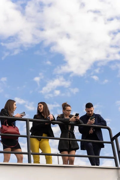 Group Young Business People Checking Phones Together While Talking — Fotografia de Stock