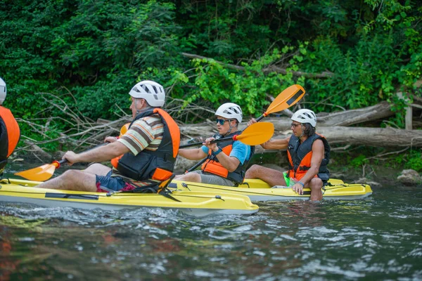 Group Senior Male Friends Canoeing Together While Having Great Time — 스톡 사진