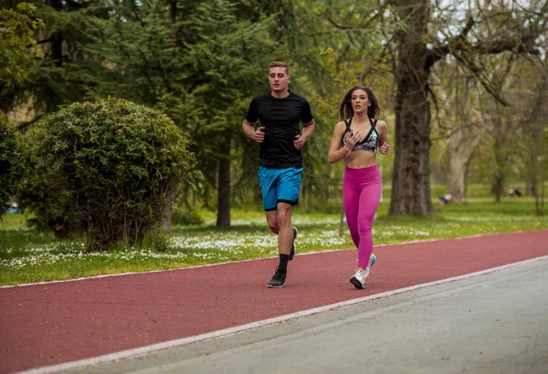 Young Couple Fit Sportsmen Boy Girl Running While Doing Exercise — Fotografia de Stock