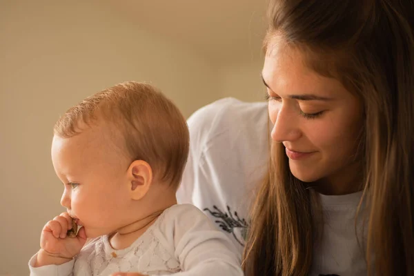 Beautiful Mother Watching Her Baby Girl Eat Bread — Stockfoto