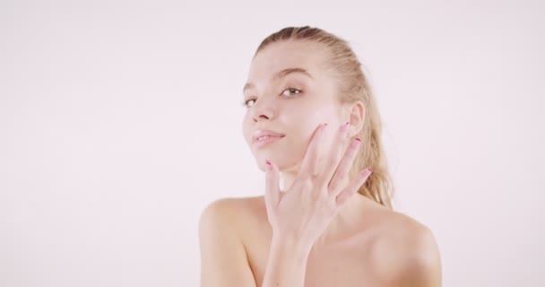 Beautiful Girl Applying White Cream Her Cheak Isolated Beige Background — Stock video