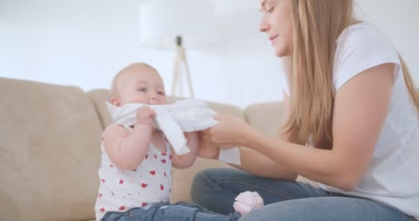 Joven Madre Ayudando Pequeño Bebé Ponerse Pijama — Vídeos de Stock